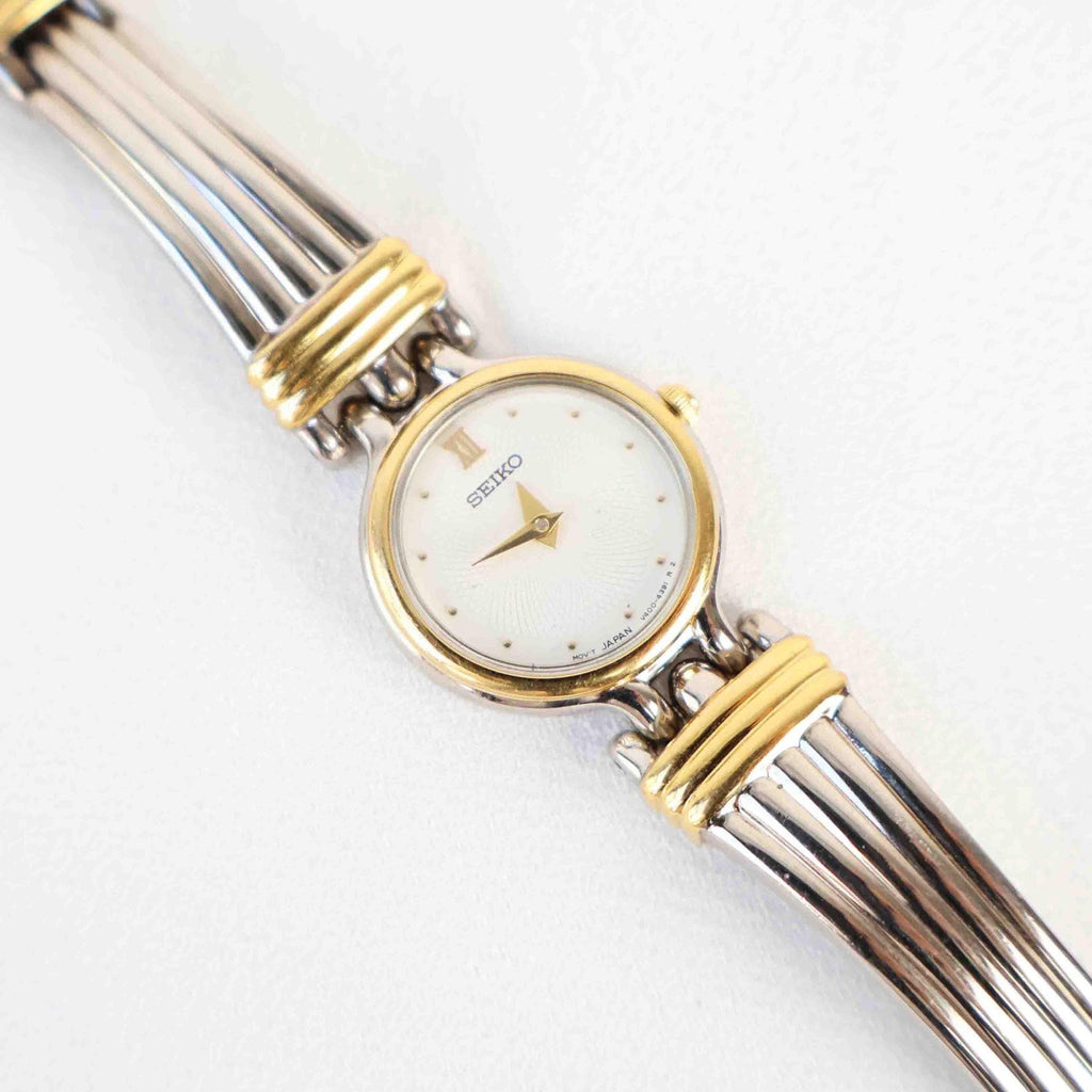Vintage Two Tone Seiko with a White Round Face - (Working Battery)