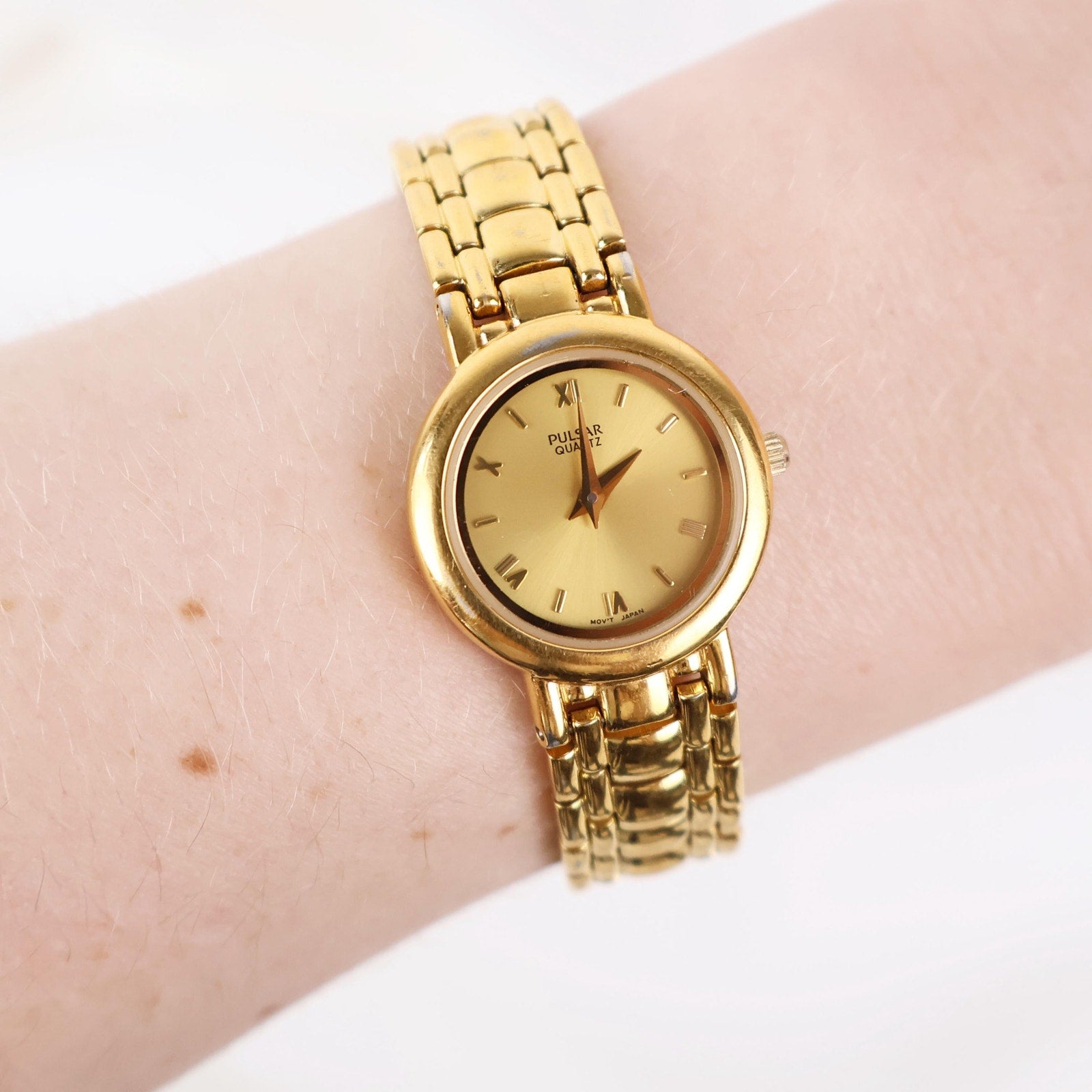 Vintage Gold Tone Pulsar Watch with a Circle Face