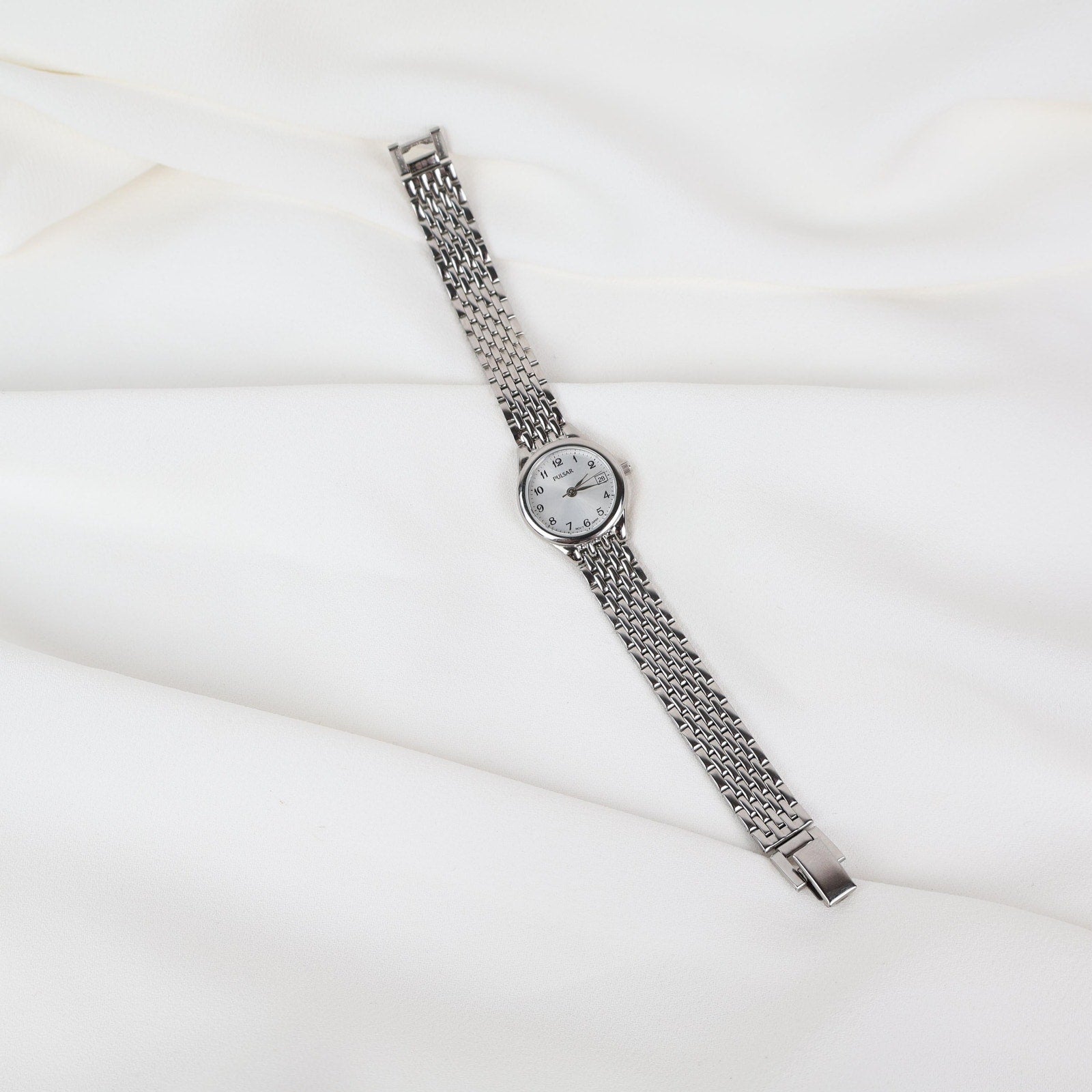 Vintage Silver Pulsar Watch with a Round Face