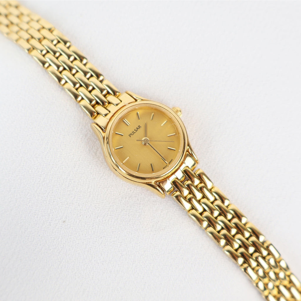 Vintage Gold Tone Pulsar Watch with a Circle Face