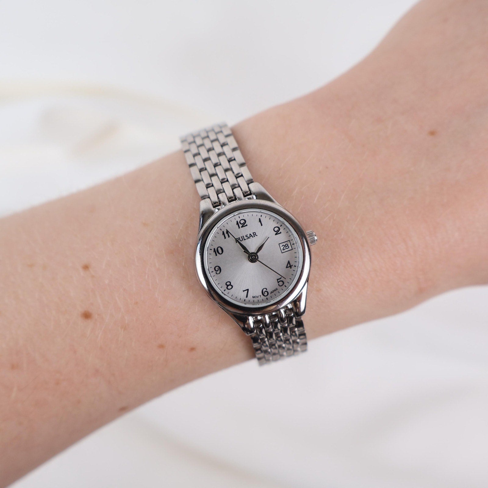 Vintage Silver Pulsar Watch with a Round Face