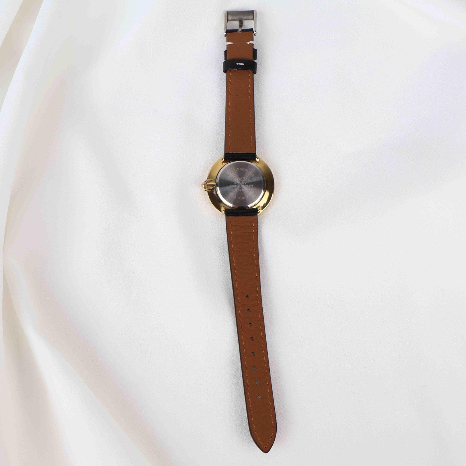 Vintage Embassy Watch with a Gold Round Face and Black Leather Strap
