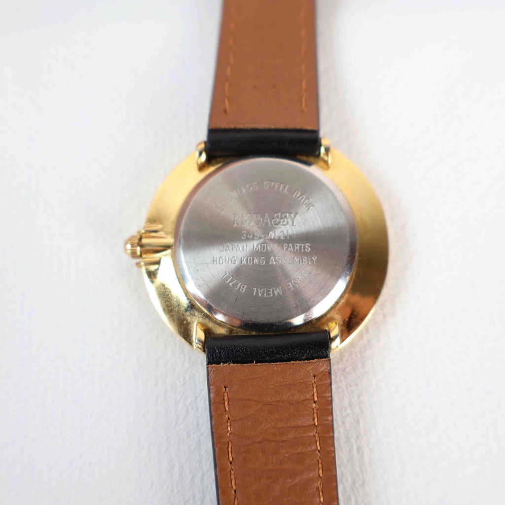 Vintage Embassy Watch with a Gold Round Face and Black Leather Strap